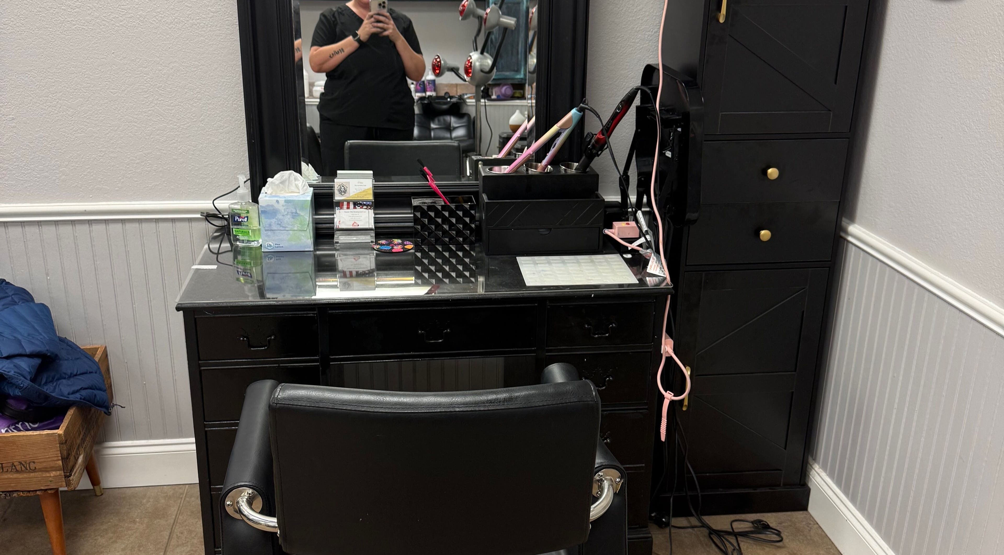 Elegant styling station at Hair by Ashley, Strawberry Plains, Tennessee, US, showcasing tools and mirror setup.