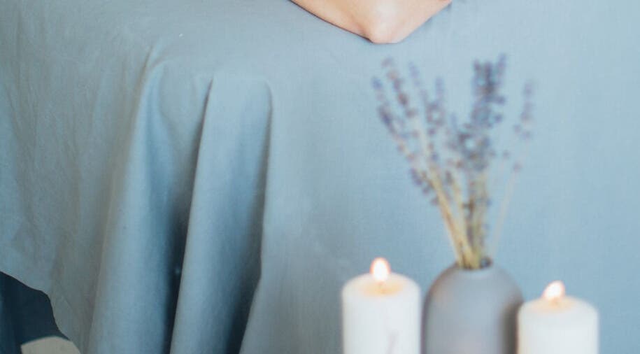Relaxing massage table with candles at Get Me Pampered, Chester, GB, creating a serene spa atmosphere.