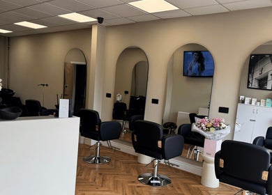 Elegant salon interior at STYLED | By Melissa, Reddish, England, GB with stylish chairs and mirrors.