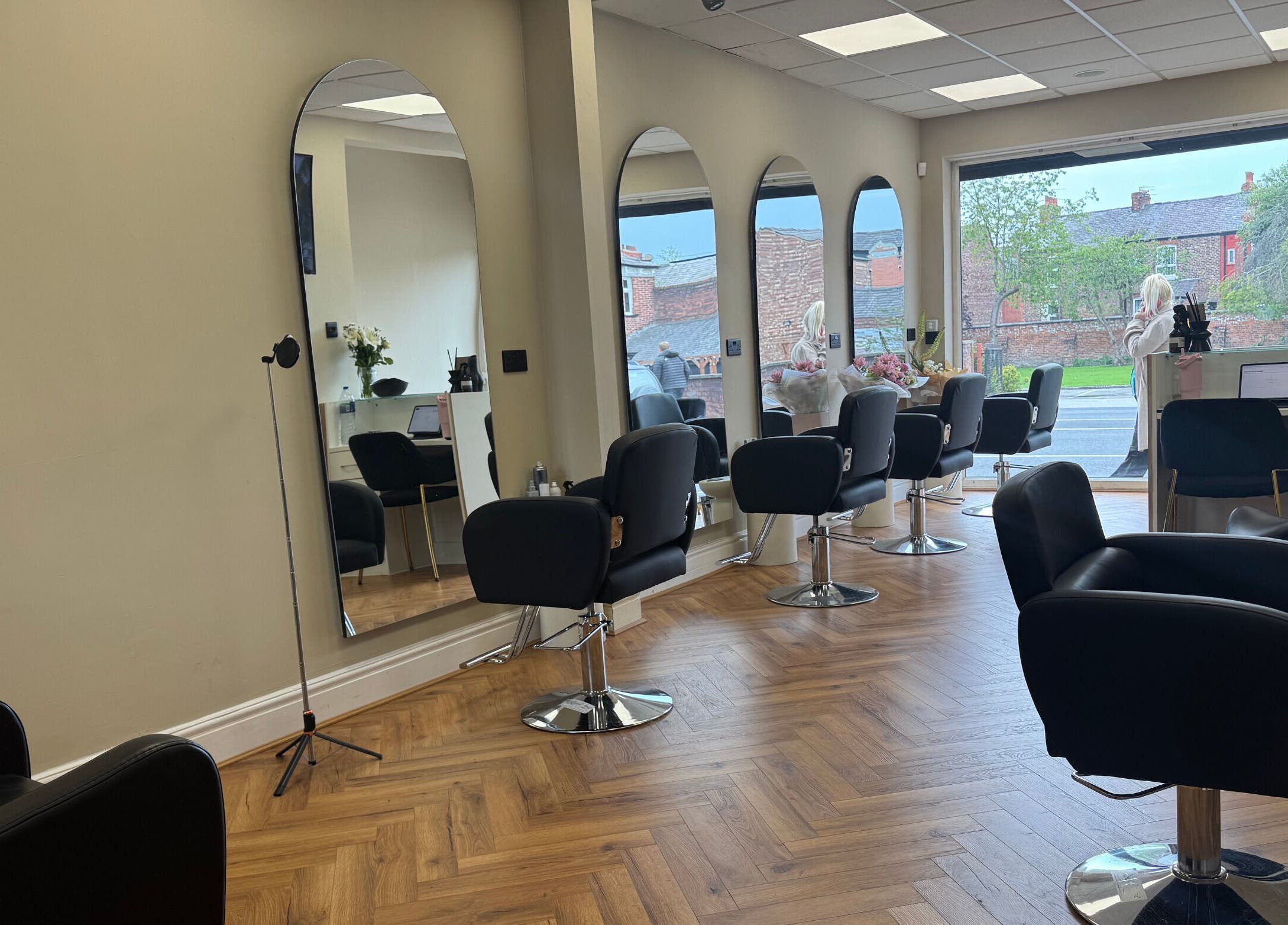 Modern salon interior at STYLED | By Melissa, Reddish, England, GB with sleek chairs and mirrors.