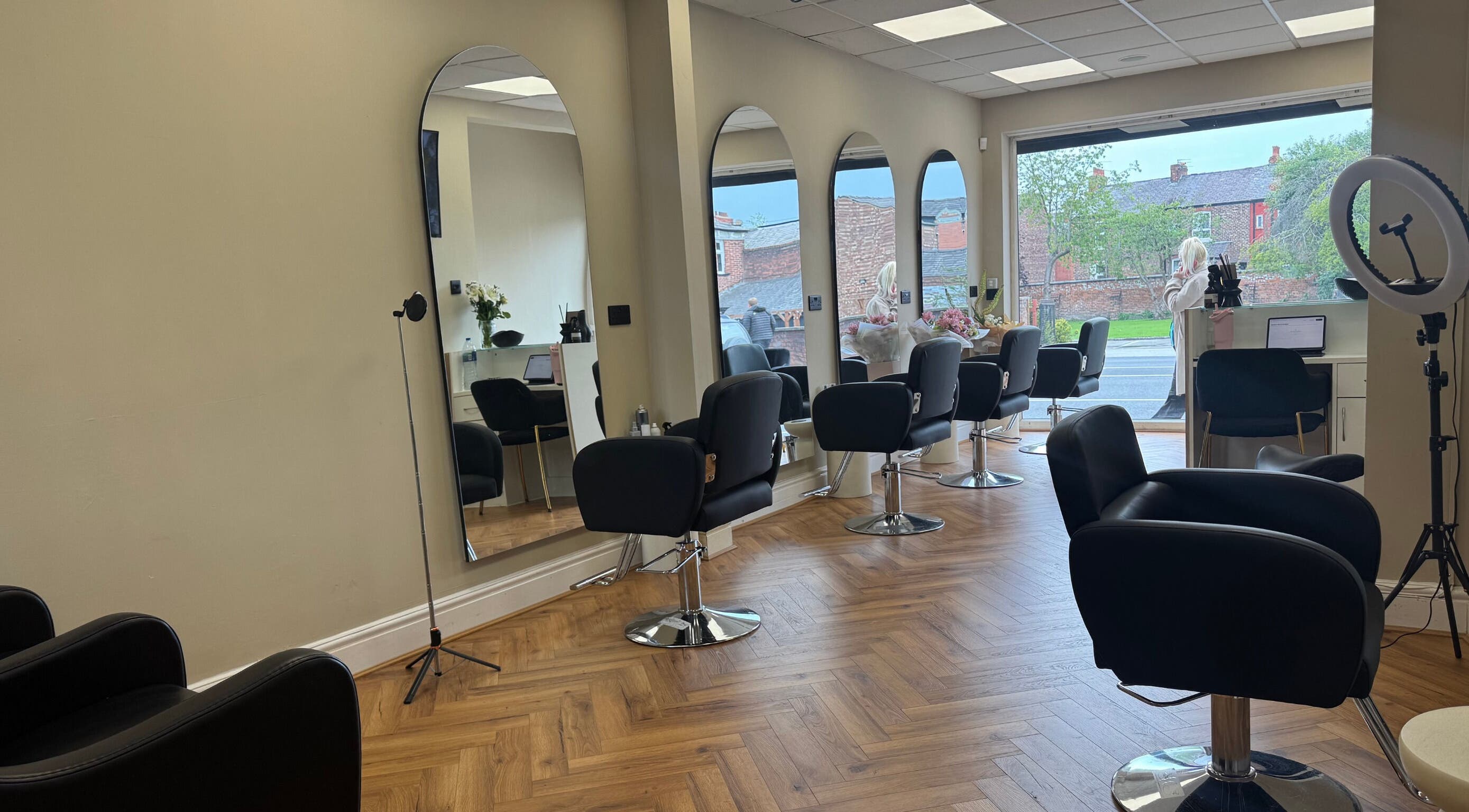 Modern salon interior at STYLED | By Melissa, Reddish, England, GB with sleek chairs and mirrors.