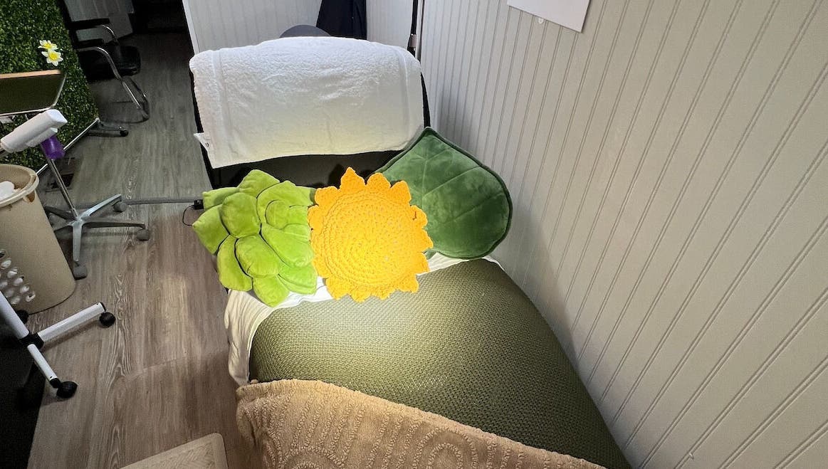 Cozy spa bed with colorful cushions at GlowLyssa Esthetics in Ada, Oklahoma, US.
