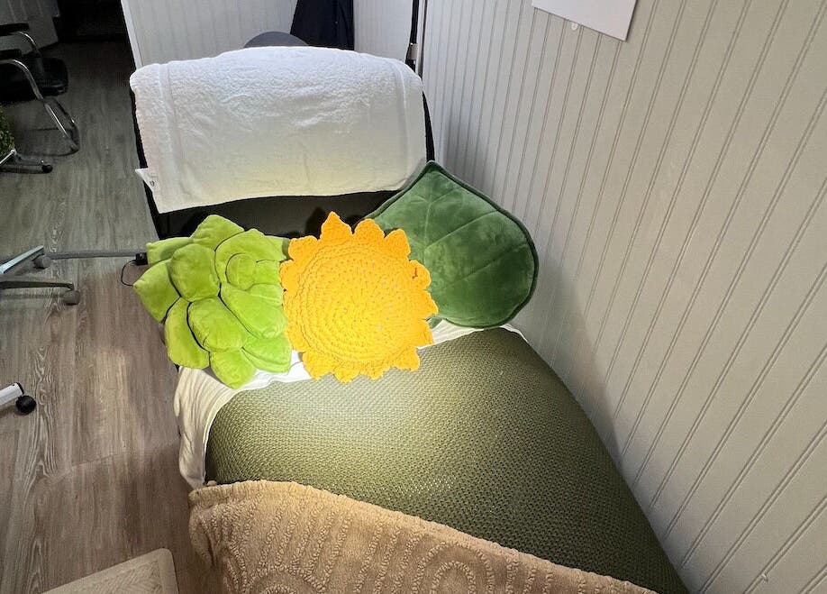 Cozy spa bed with colorful cushions at GlowLyssa Esthetics in Ada, Oklahoma, US.