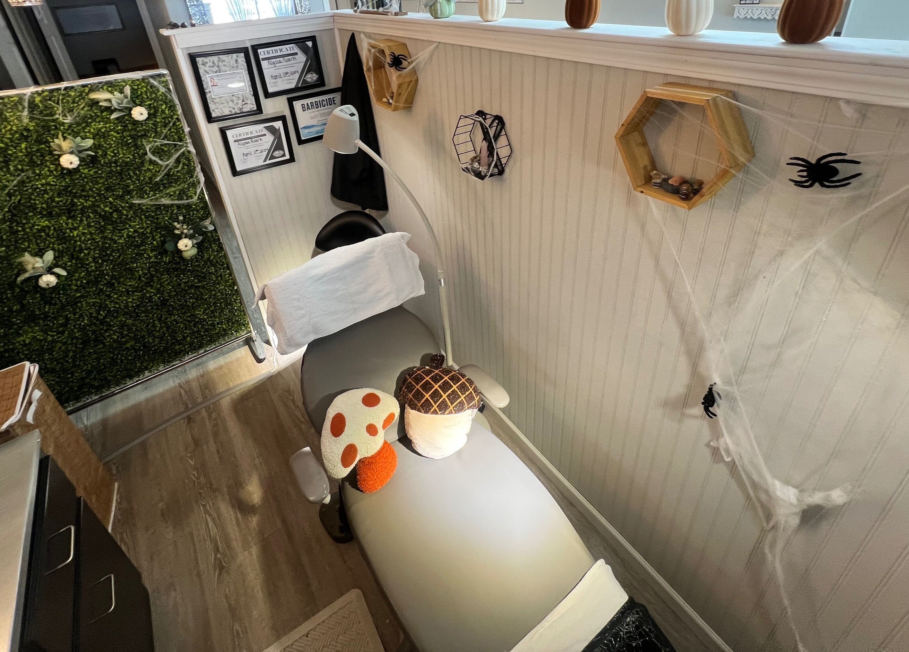 A serene treatment room at GlowLyssa Esthetics in Ada, Oklahoma, US, featuring a comfortable bed and nature decor.