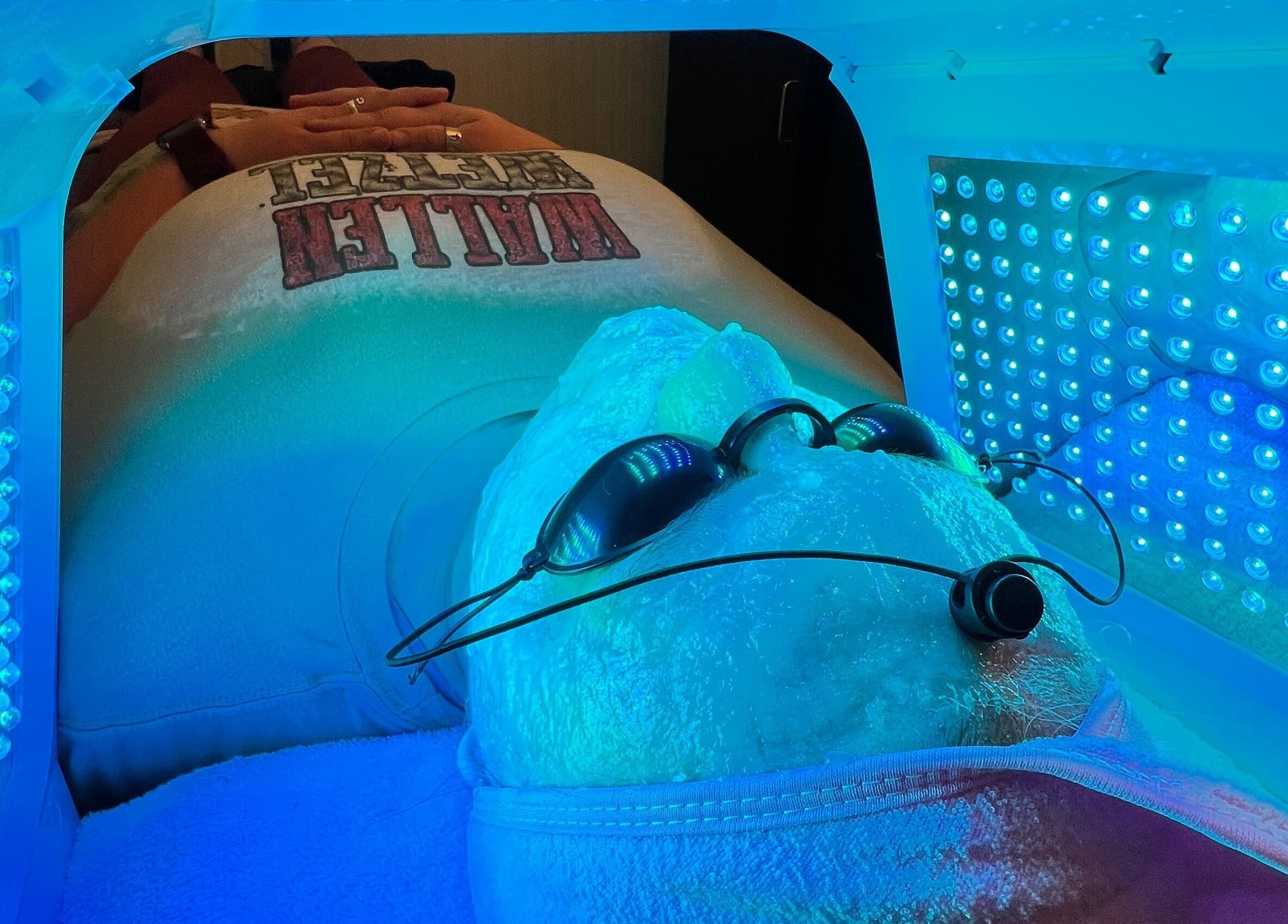 Client enjoys LED facial treatment at GlowLyssa Esthetics, Ada, Oklahoma, US, under therapeutic blue light.