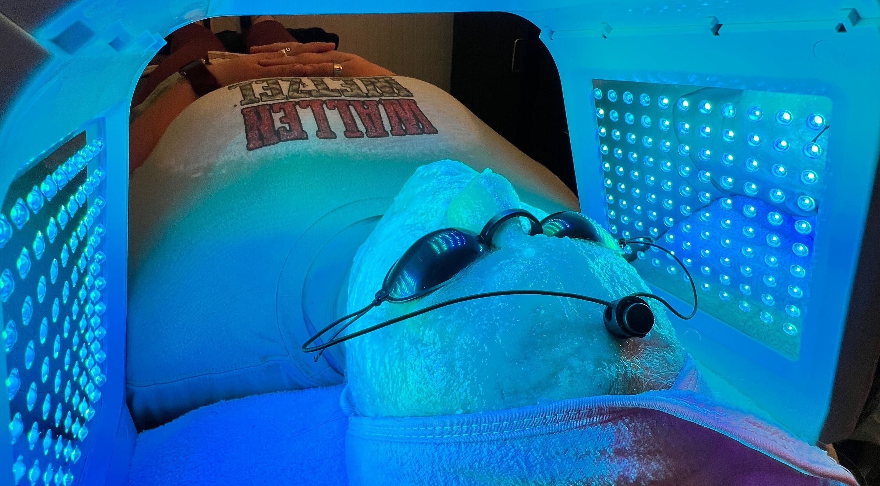 Client enjoys LED facial treatment at GlowLyssa Esthetics, Ada, Oklahoma, US, under therapeutic blue light.