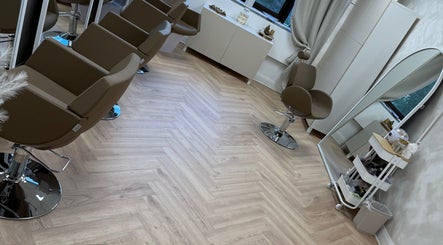 Modern interior of Chris Loen Hair Studio in Clydebank, Scotland, GB with stylish brown chairs and mirrors.