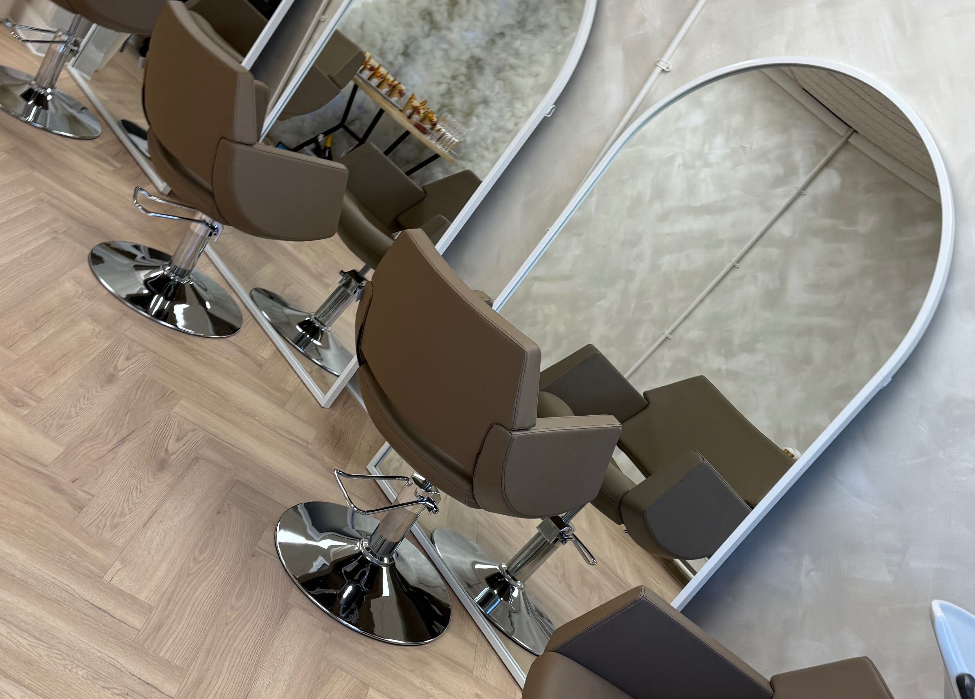 Modern salon chairs and mirrors at Chris Loen Hair Studio in Clydebank, Scotland, GB.