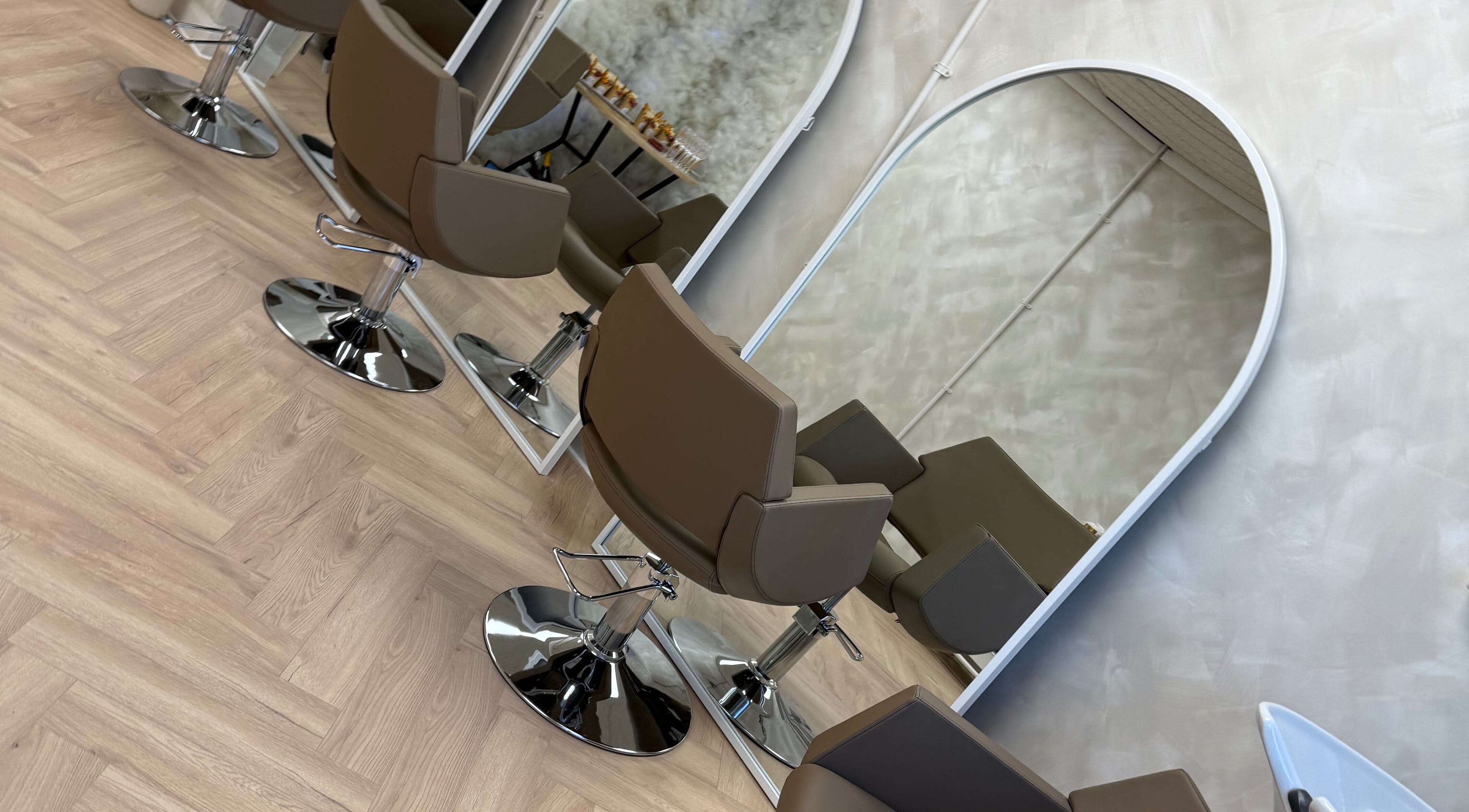 Modern salon chairs and mirrors at Chris Loen Hair Studio in Clydebank, Scotland, GB.
