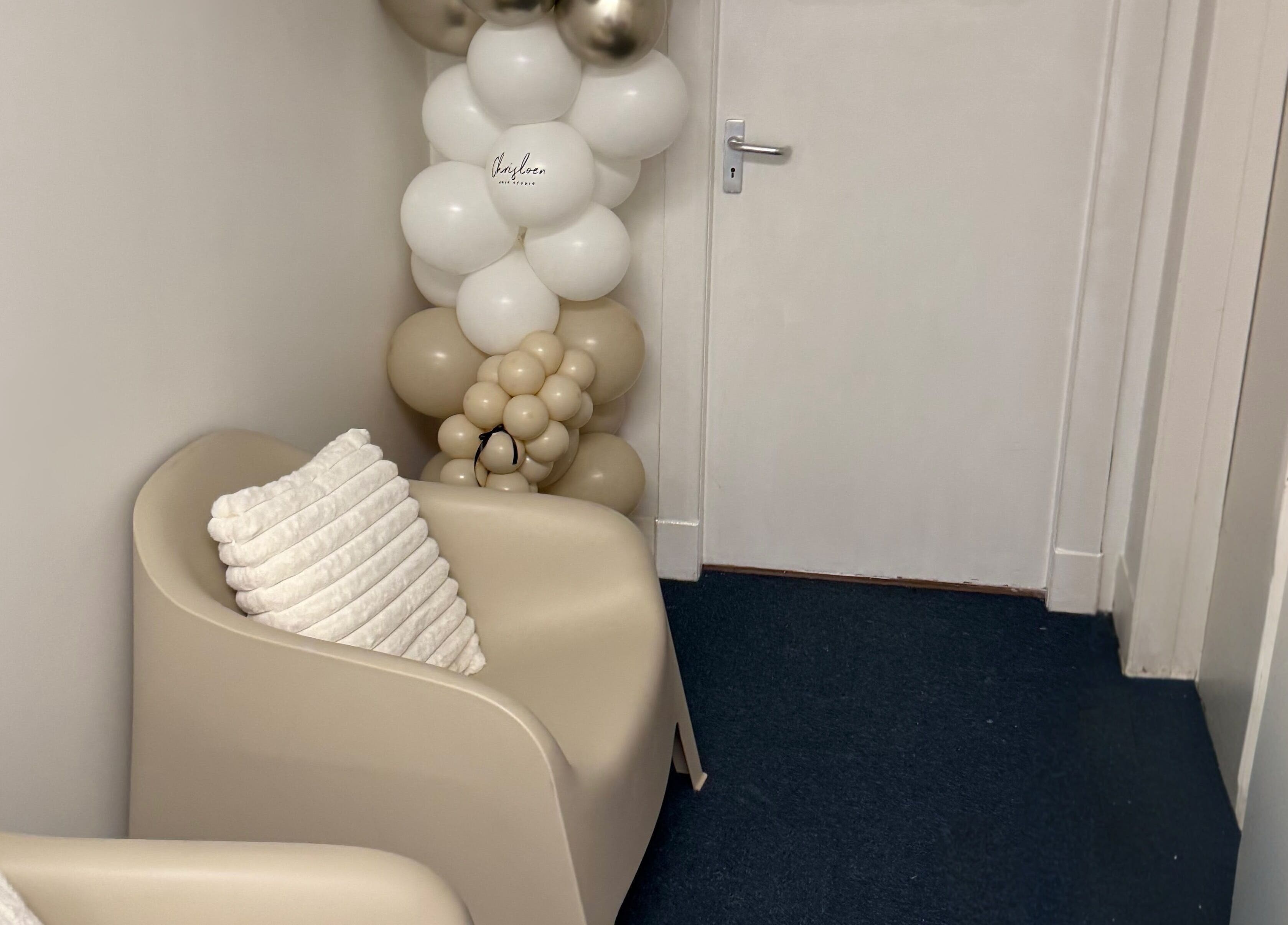 Inviting seating area at Chris Loen Hair Studio, Clydebank, Scotland, GB, featuring elegant decor and plush pillows.