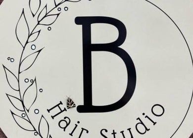 Stylish hair studio sign at Anastasia, Taunton, England, GB, with decorative leaf design.