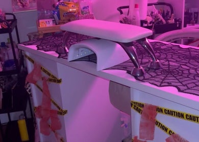 PEARADISE nail station, Baltimore, Maryland, US, adorned with purple lighting and Halloween decor.
