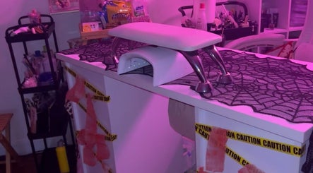 PEARADISE nail station, Baltimore, Maryland, US, adorned with purple lighting and Halloween decor.
