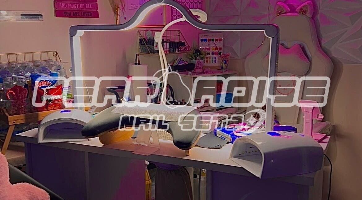 Stylish nail station at Supa Swag Setz by Soulja, Baltimore, Maryland, US, featuring vibrant decor and tools.