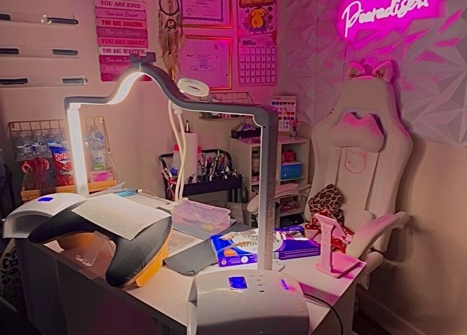 A cozy beauty space in Pearadise, Baltimore, Maryland, US, with a well-equipped manicure station and pink decor.