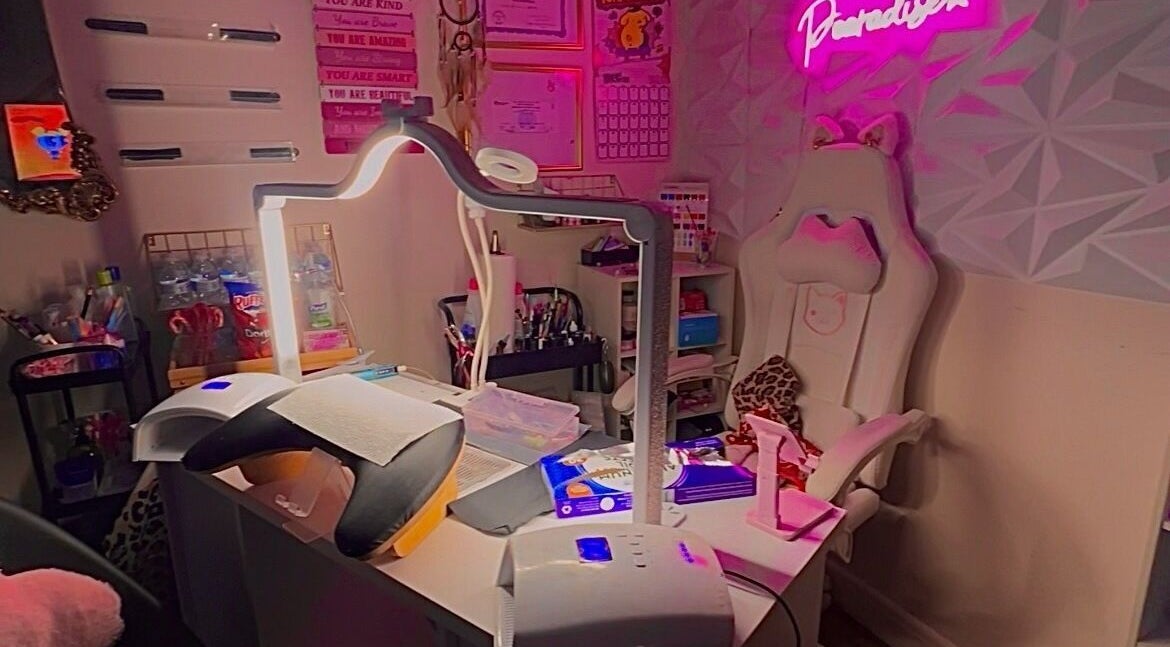 A cozy beauty space in Pearadise, Baltimore, Maryland, US, with a well-equipped manicure station and pink decor.