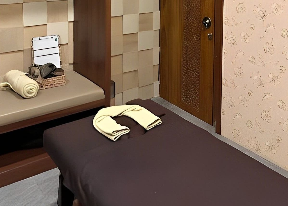 Relaxing massage room at Spa Central Jogja, Daerah Istimewa Yogyakarta, ID, featuring a comfortable massage bed.