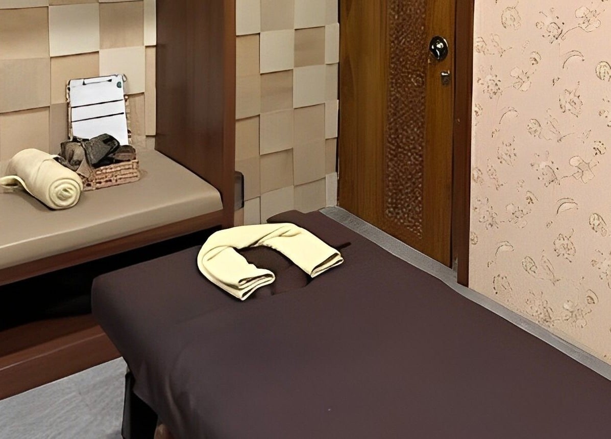 Relaxing massage room at Spa Central Jogja, Daerah Istimewa Yogyakarta, ID, featuring a comfortable massage bed.