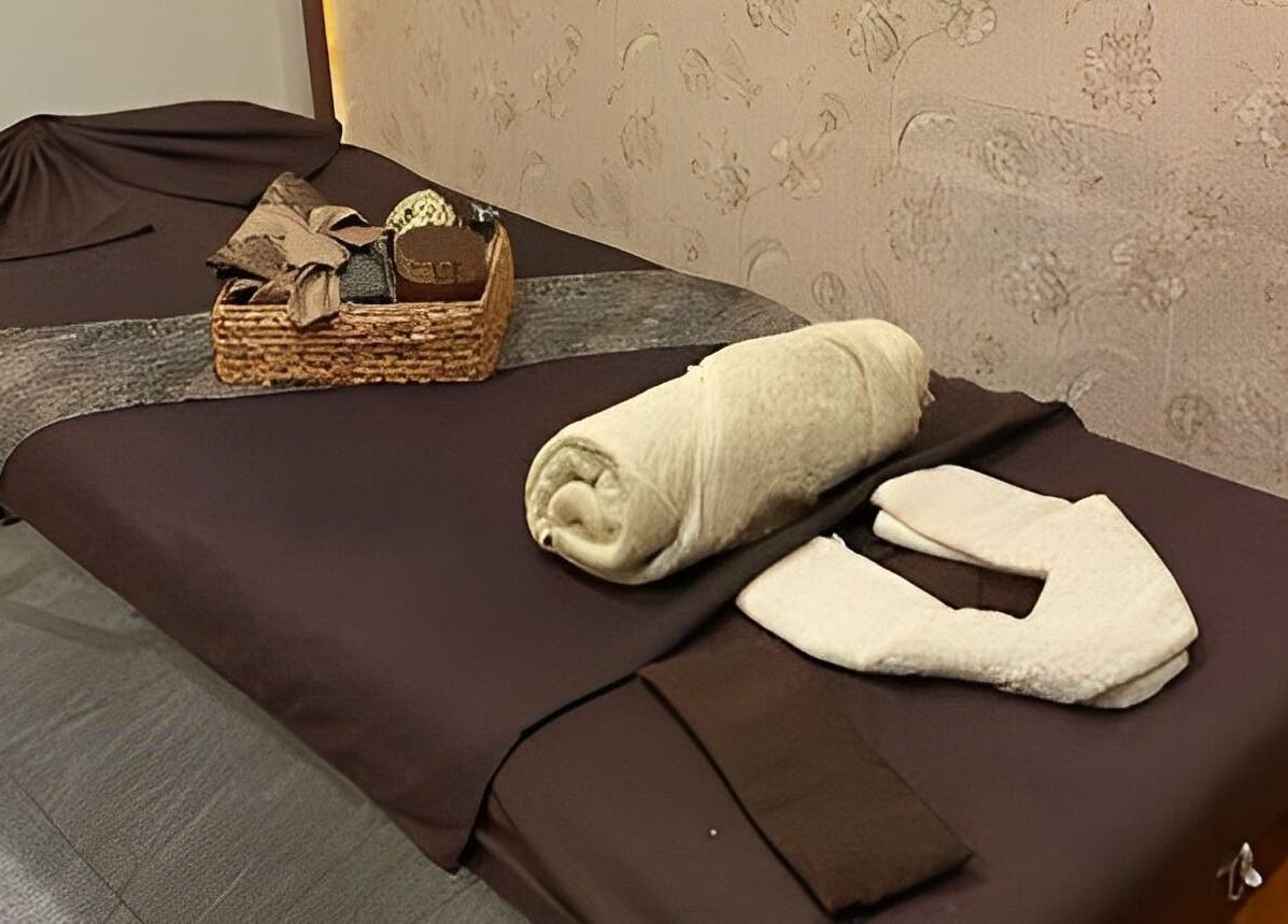 Relaxing massage bed setup at Spa Central Jogja, Daerah Istimewa Yogyakarta, ID, featuring cozy towels.