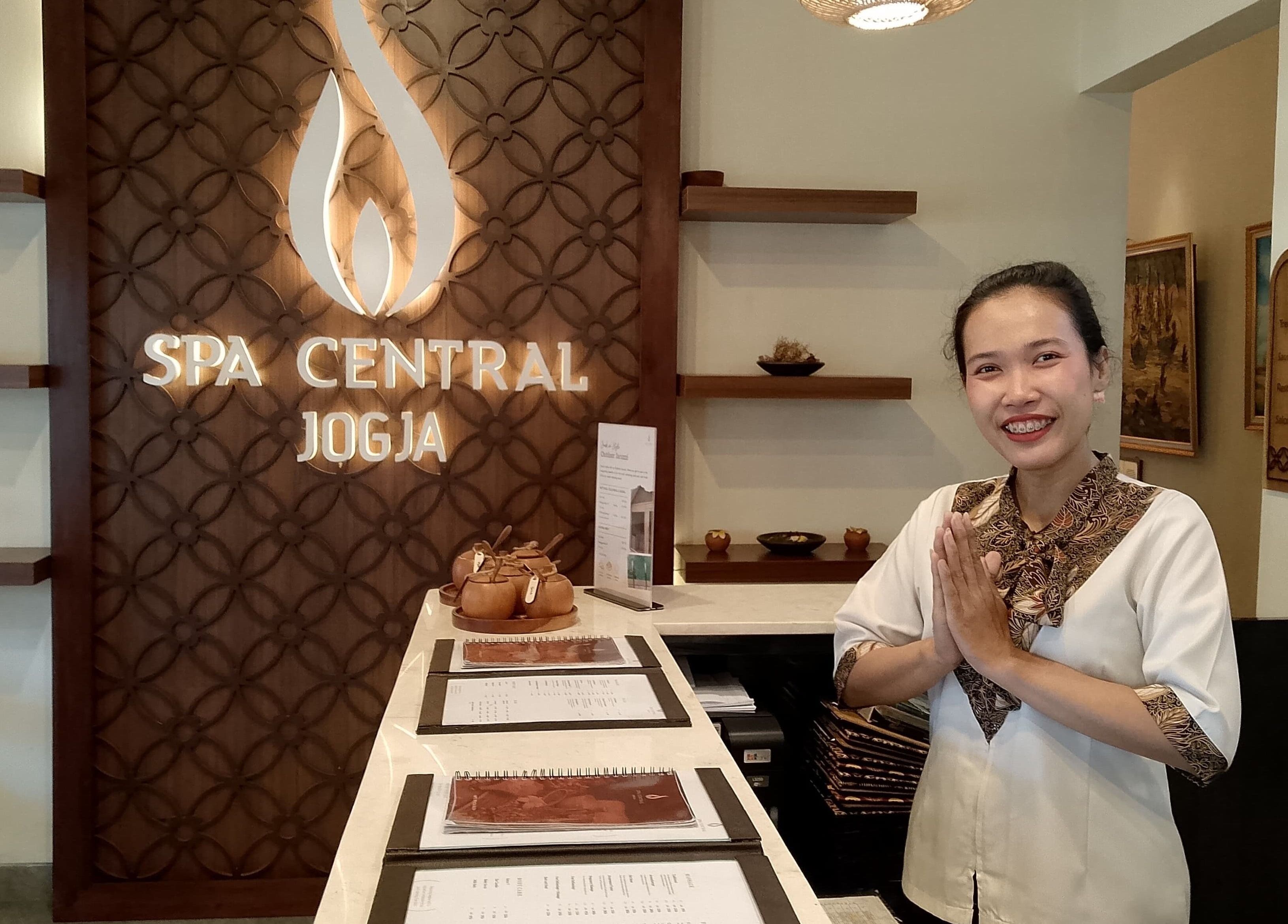 Friendly receptionist at Spa Central Jogja, Daerah Istimewa Yogyakarta, ID, ready to greet customers warmly.