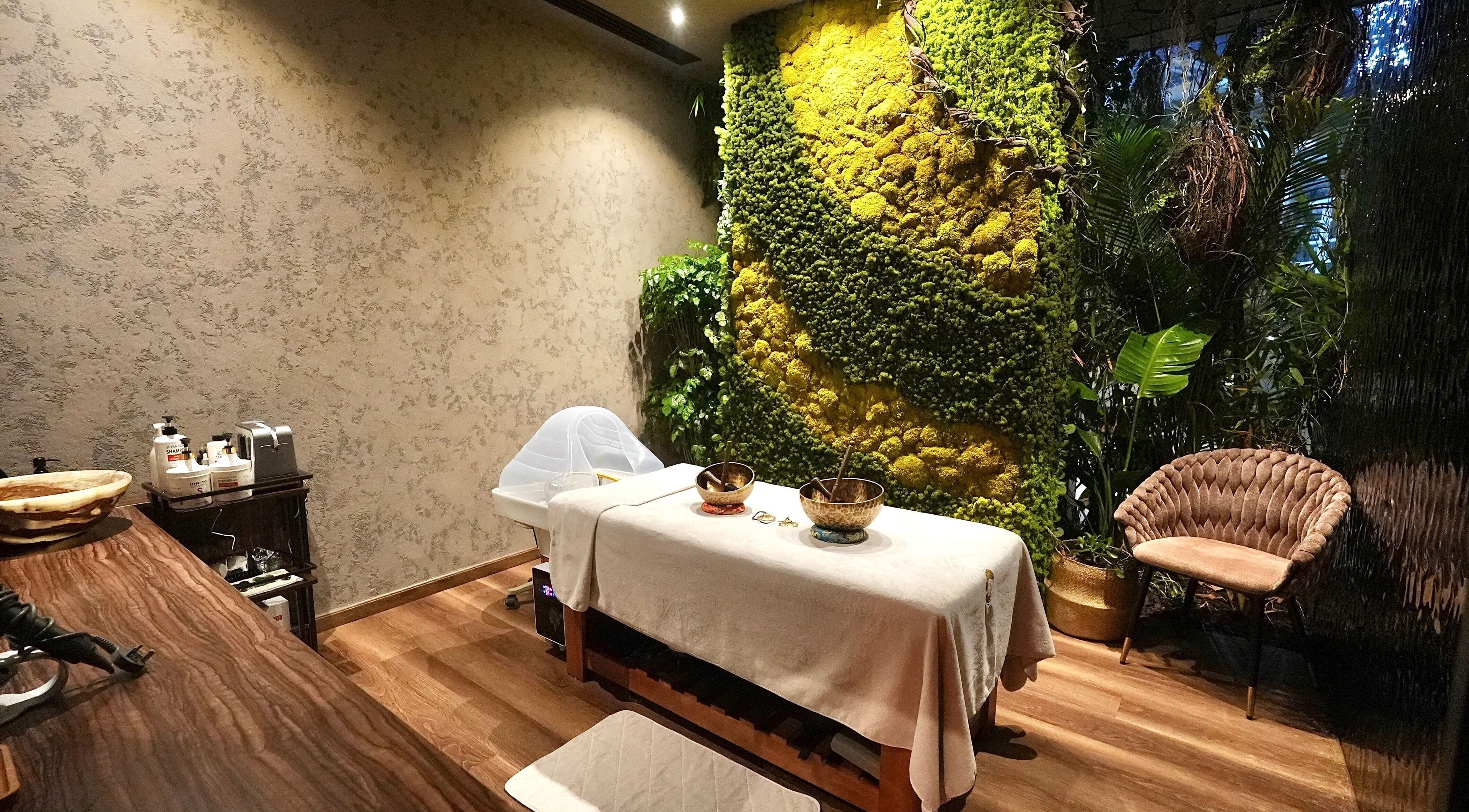Serene treatment room at Adara Spa Retreat, Ladies Spa, Dubai, Dubai, AE, featuring lush greenery and cozy seating.