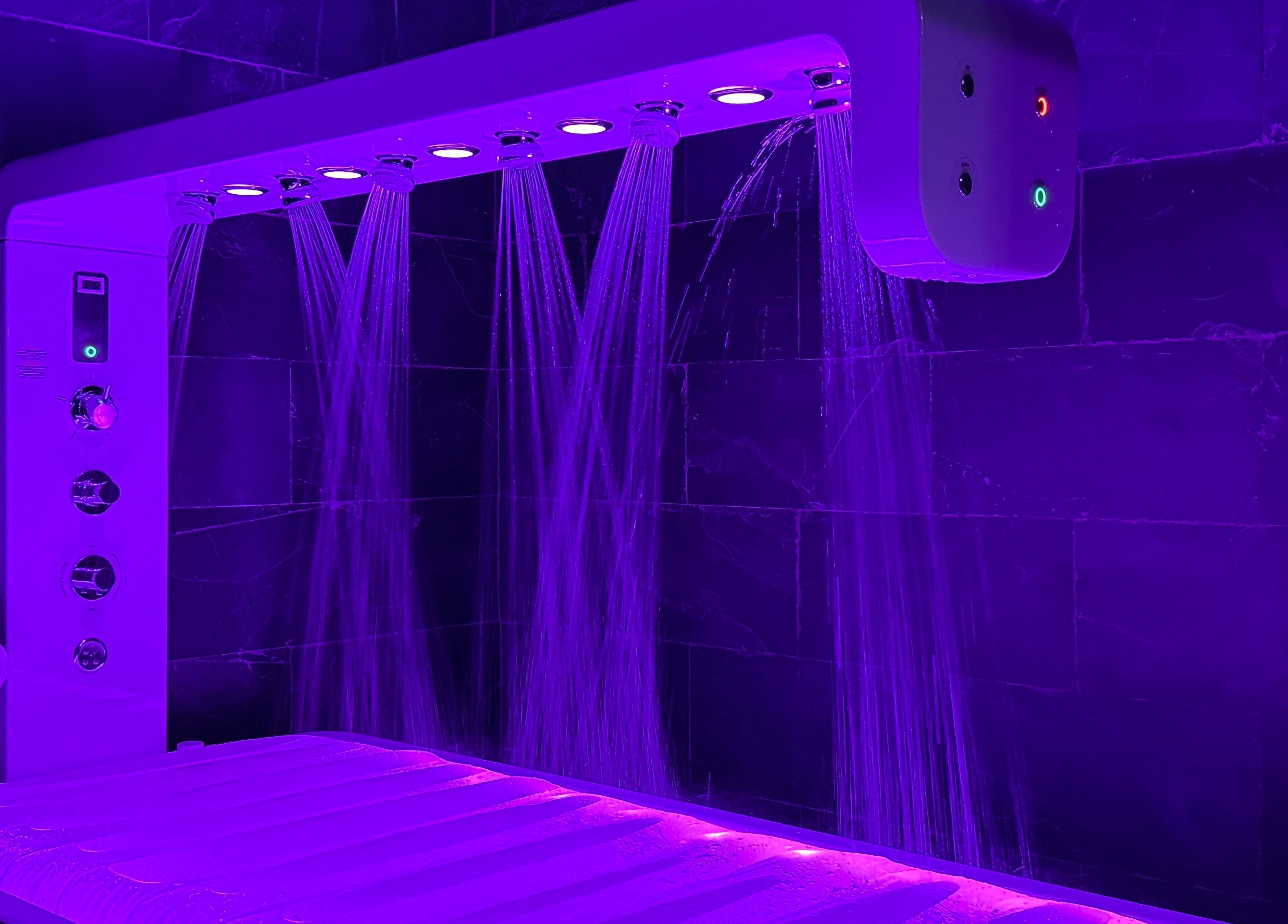 Vichy shower at Adara Spa Retreat, Ladies Spa in Dubai, AE. Experience relaxation with soothing purple lighting.