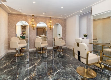 Modern salon chairs and mirrors at George Vallossian, London, England, GB, exuding luxury and style.