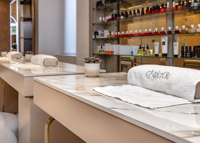 Elegant beauty lounge at George Vallossian, London, England, GB showcasing plush seating and luxury products.