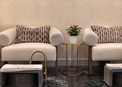 Elegant seating area at George Vallossian, London, England, GB showcasing plush chairs and stylish decor.