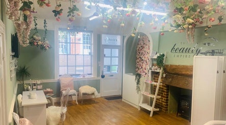 Elegant beauty salon interior at Skin & Vain, Lawford, England, GB, featuring floral decor and cozy seating.