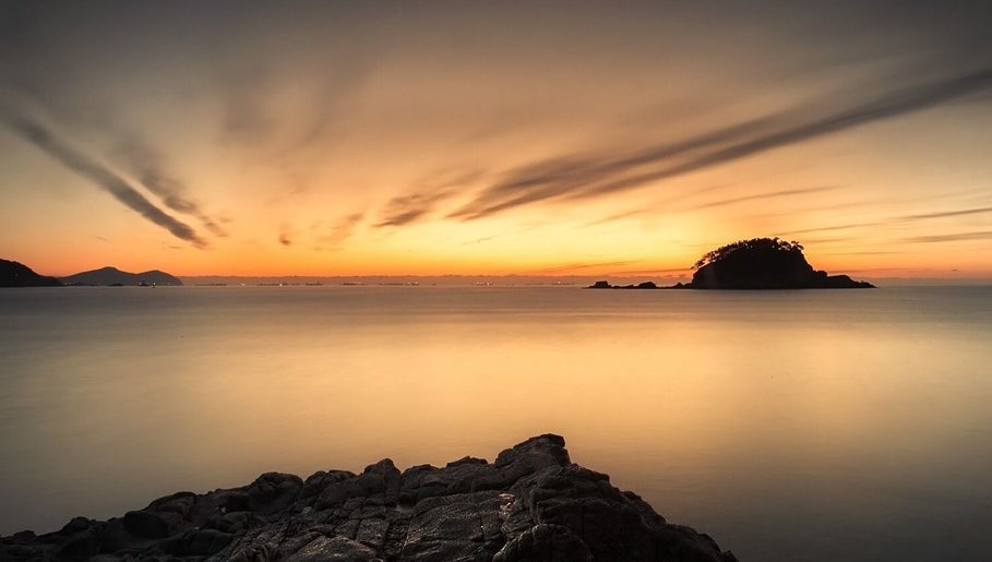 Sunset over calm sea near Tesla in Guaynabo, Guaynabo, PR, ideal for relaxation and wellness.