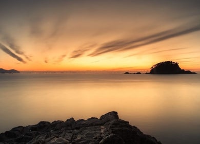 Sunset over calm sea near Tesla in Guaynabo, Guaynabo, PR, ideal for relaxation and wellness.