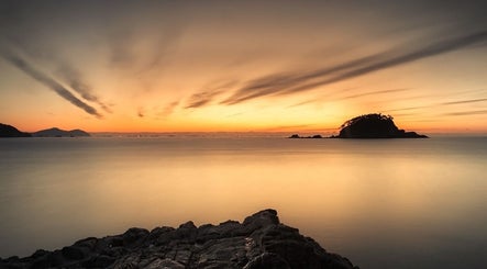 Sunset over calm sea near Tesla in Guaynabo, Guaynabo, PR, ideal for relaxation and wellness.