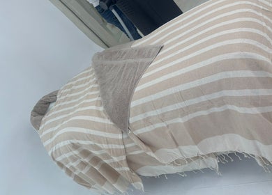 Relaxing treatment bed at Chemist Aesthetics Liverpool, Liverpool, England, GB, covered with striped linens.
