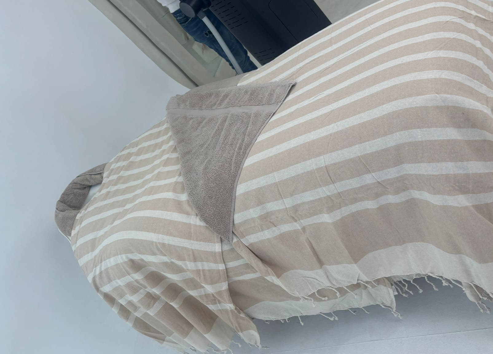 Comfortable spa bed at Chemist Aesthetics Liverpool, featuring beige stripes, Liverpool, England, GB.