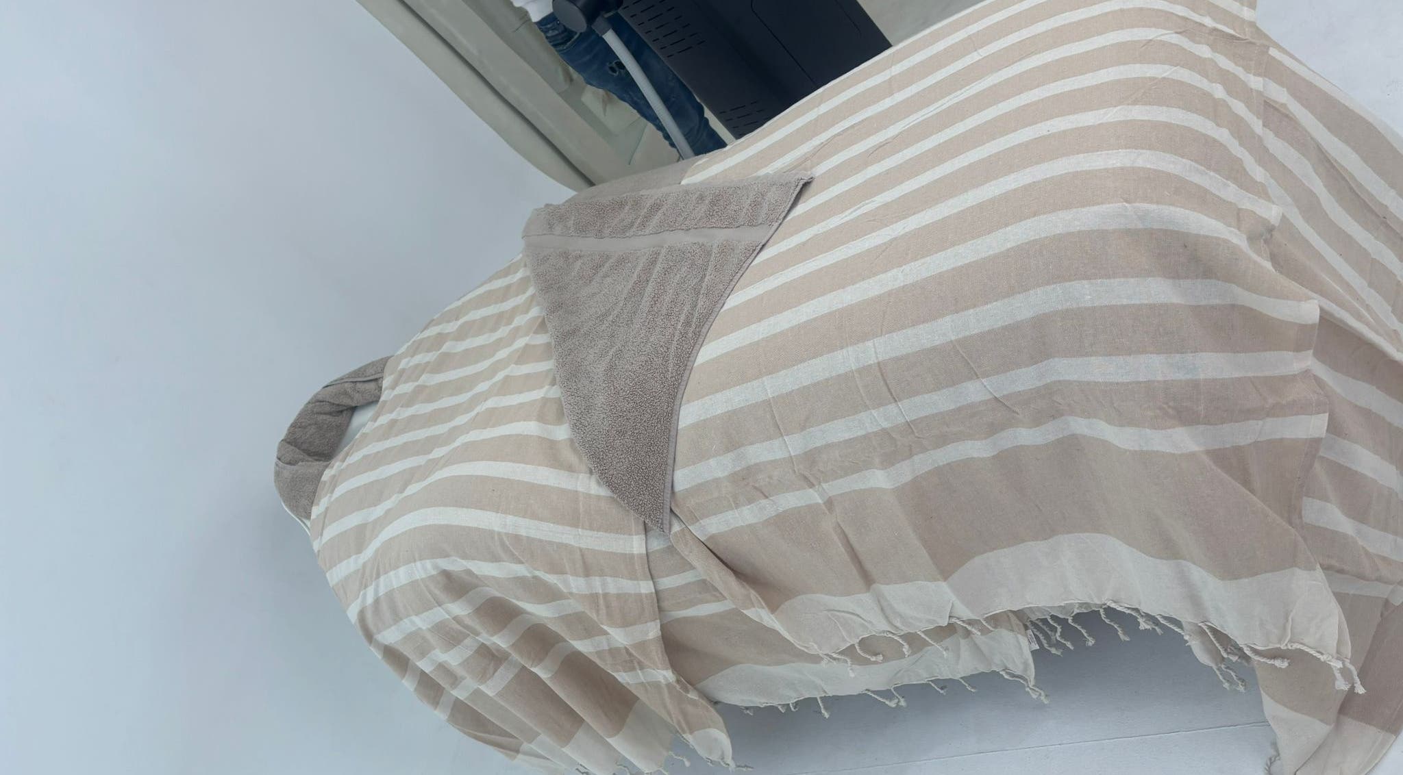 Comfortable spa bed at Chemist Aesthetics Liverpool, featuring beige stripes, Liverpool, England, GB.