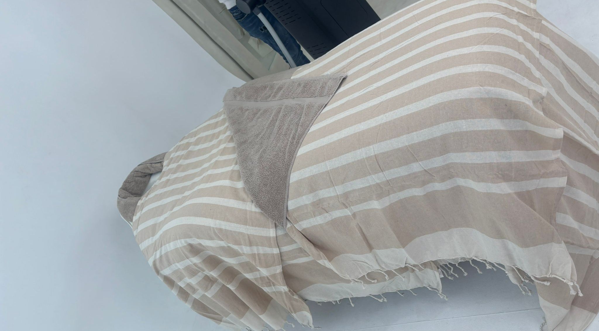 Comfortable spa bed at Chemist Aesthetics Liverpool, featuring beige stripes, Liverpool, England, GB.