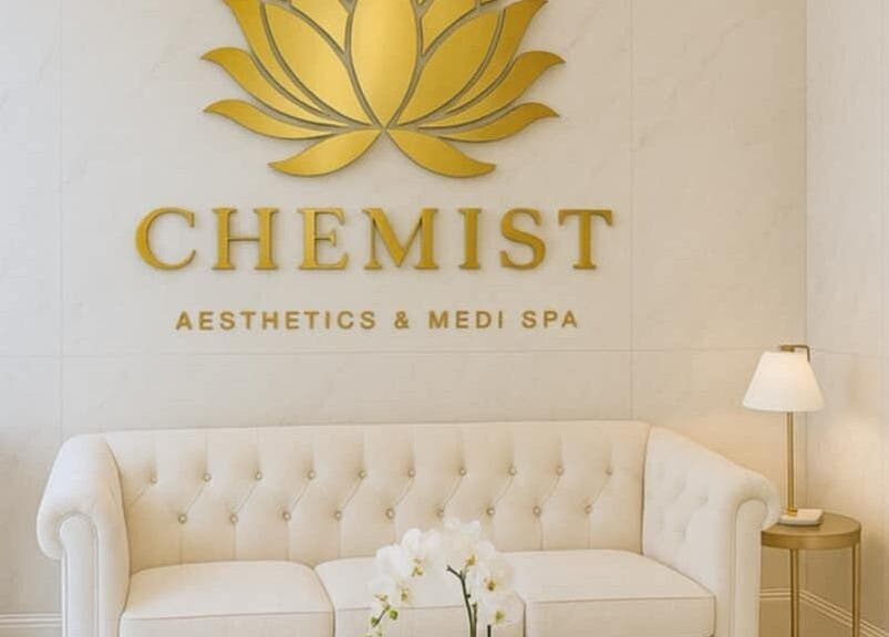 Elegant Chemist Aesthetics Liverpool waiting area with white sofa and gold decor, Liverpool, England, GB.