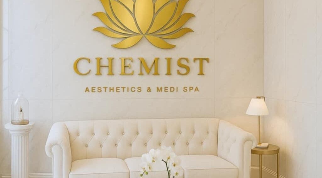 Elegant Chemist Aesthetics Liverpool waiting area with white sofa and gold decor, Liverpool, England, GB.