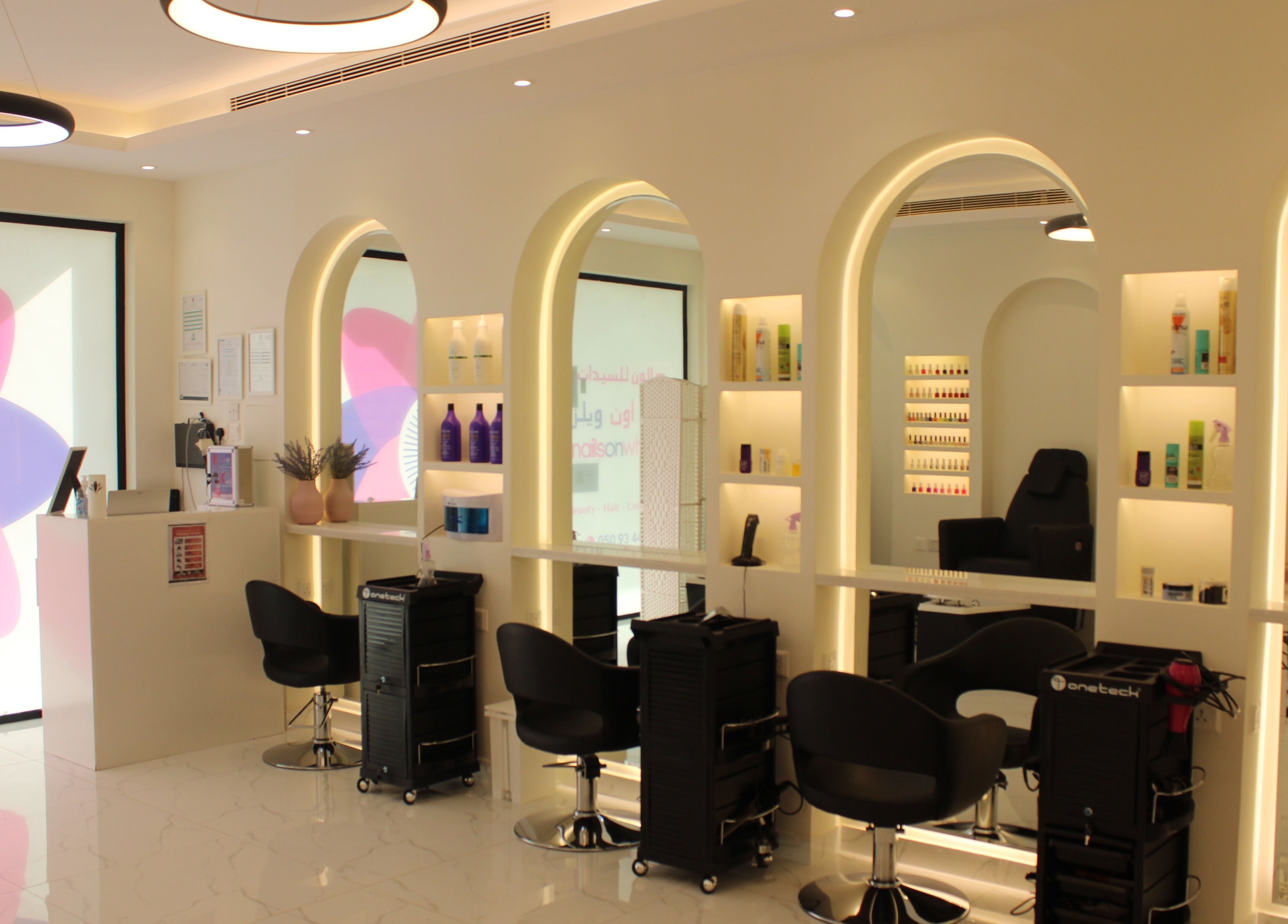 Sleek salon interior of Nails on Wheels in الرياض, منطقة الرياض, SA featuring modern styling stations.