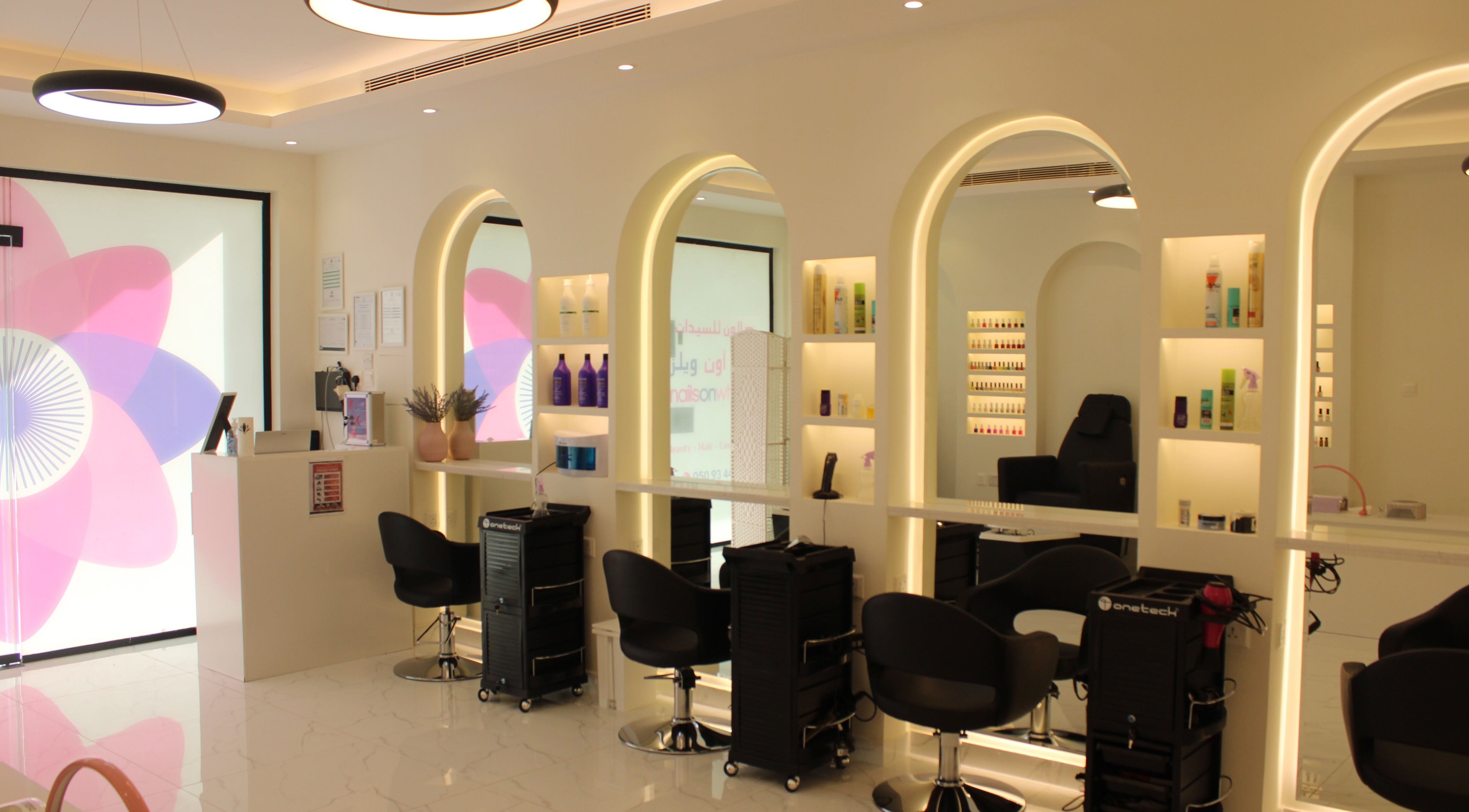 Sleek salon interior of Nails on Wheels in الرياض, منطقة الرياض, SA featuring modern styling stations.
