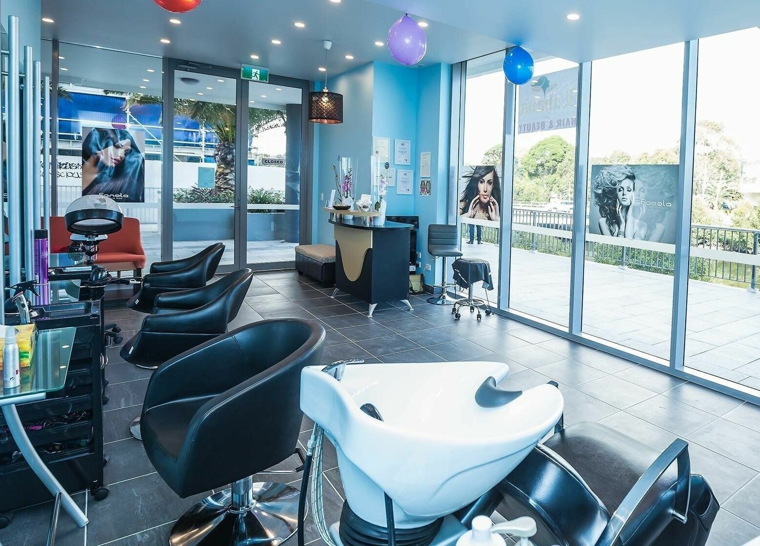 Interior of Lahana Hair & Beauty salon in Canterbury, New South Wales, AU showcasing modern chairs and styling stations.