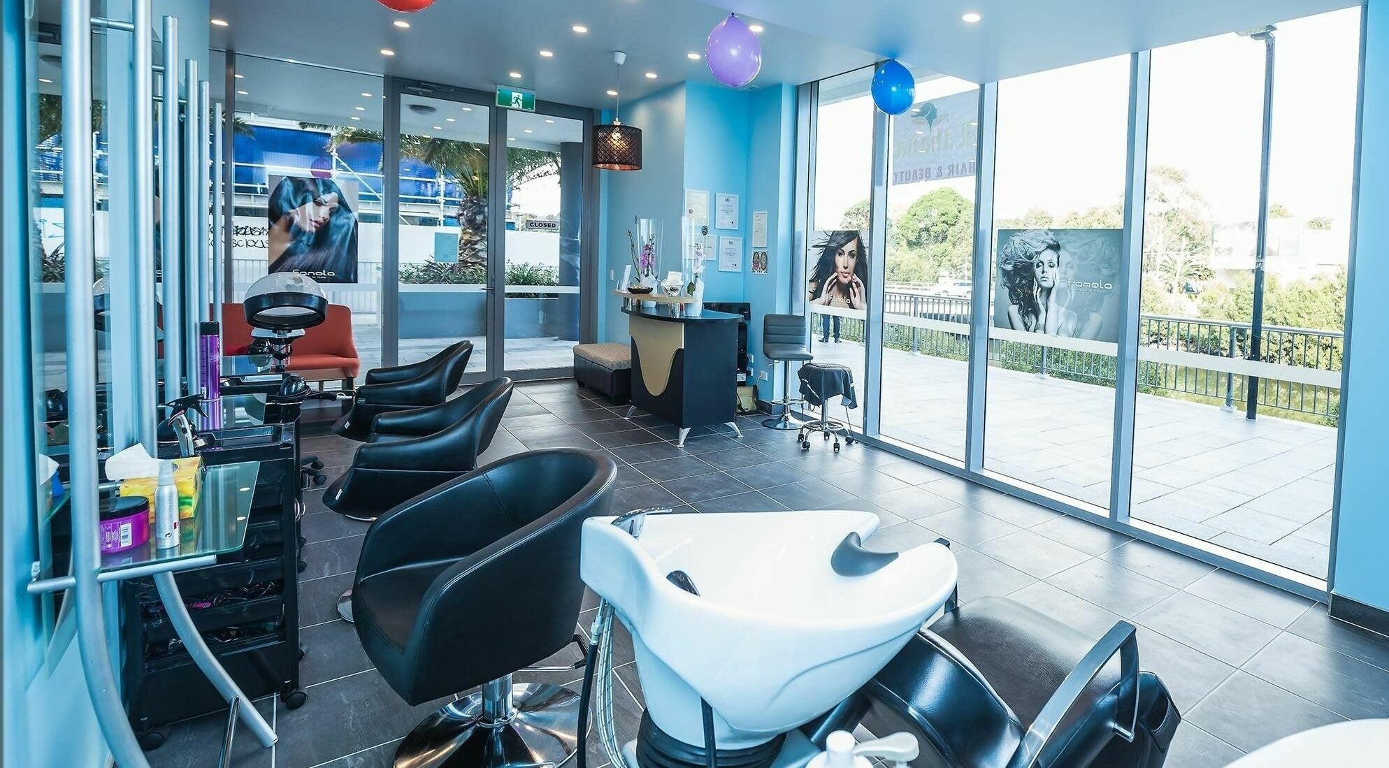 Interior of Lahana Hair & Beauty salon in Canterbury, New South Wales, AU showcasing modern chairs and styling stations.