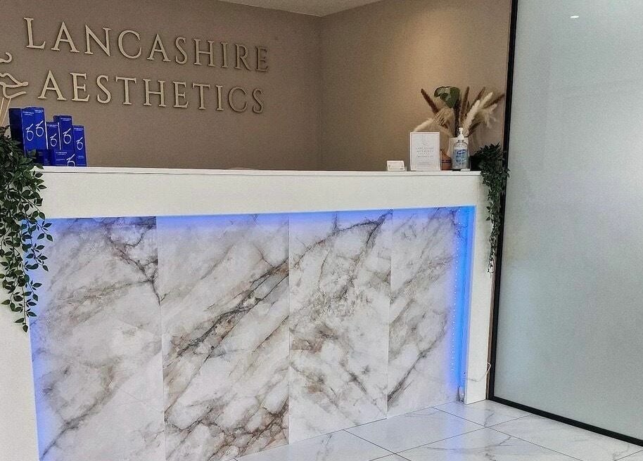 Sophisticated reception area at RENU By Amber, Bamber Bridge, England, GB with marble counter and decor.