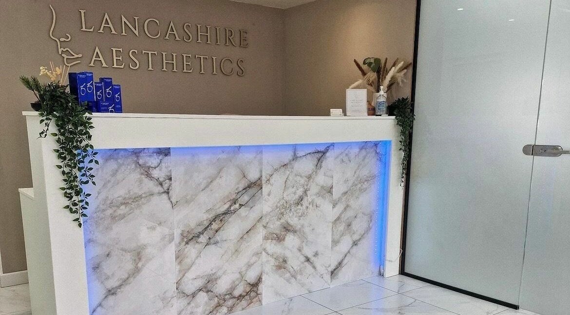 Sophisticated reception area at RENU By Amber, Bamber Bridge, England, GB with marble counter and decor.