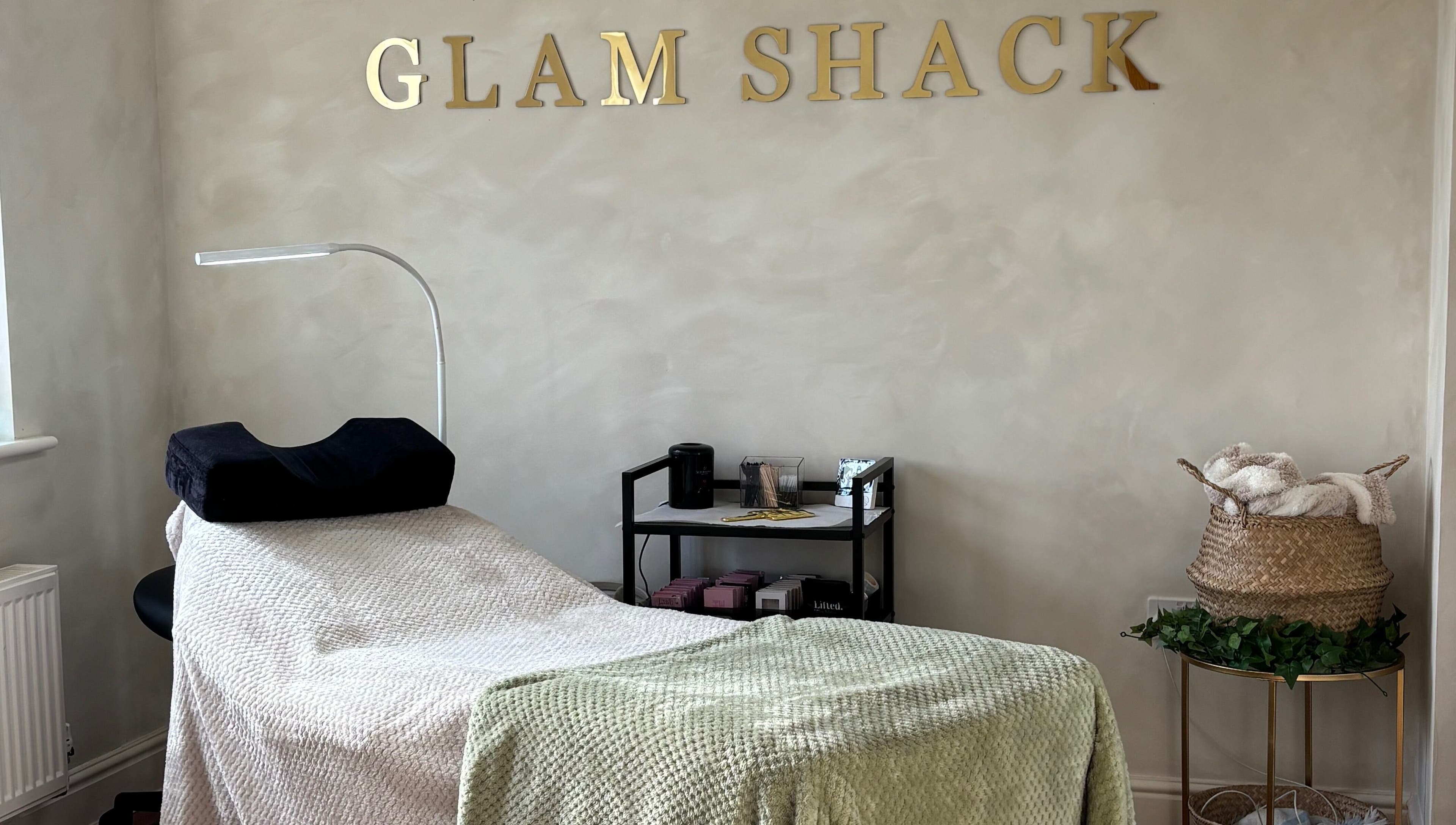 Relaxing treatment room at The Glam Shack in Mawsley, England, GB, with cozy decor and modern amenities.