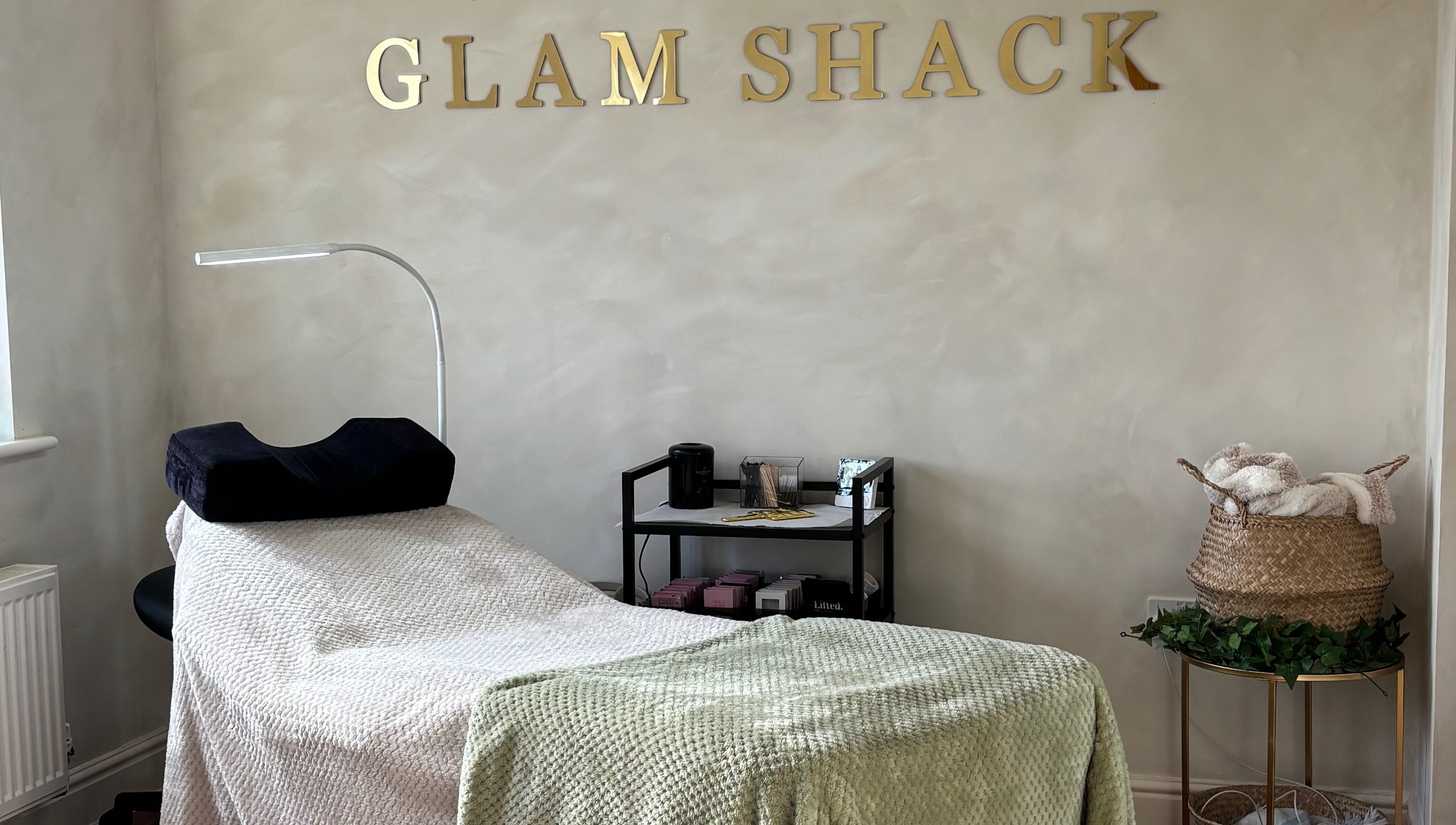 Relaxing treatment room at The Glam Shack in Mawsley, England, GB, with cozy decor and modern amenities.