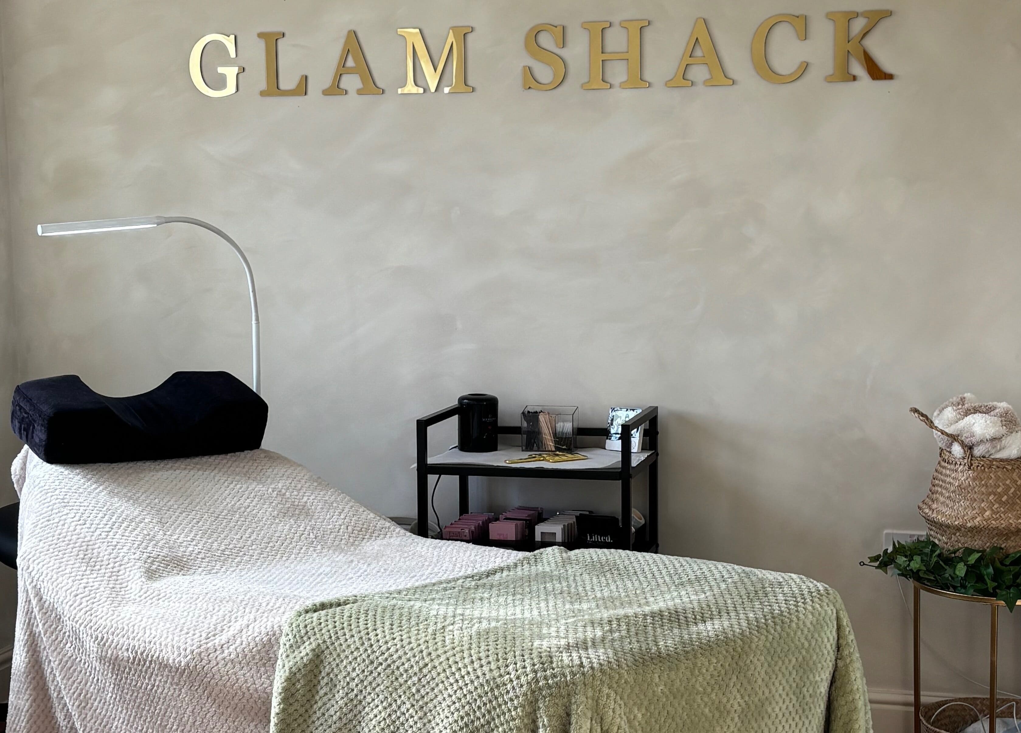 Relaxing treatment room at The Glam Shack in Mawsley, England, GB, with cozy decor and modern amenities.