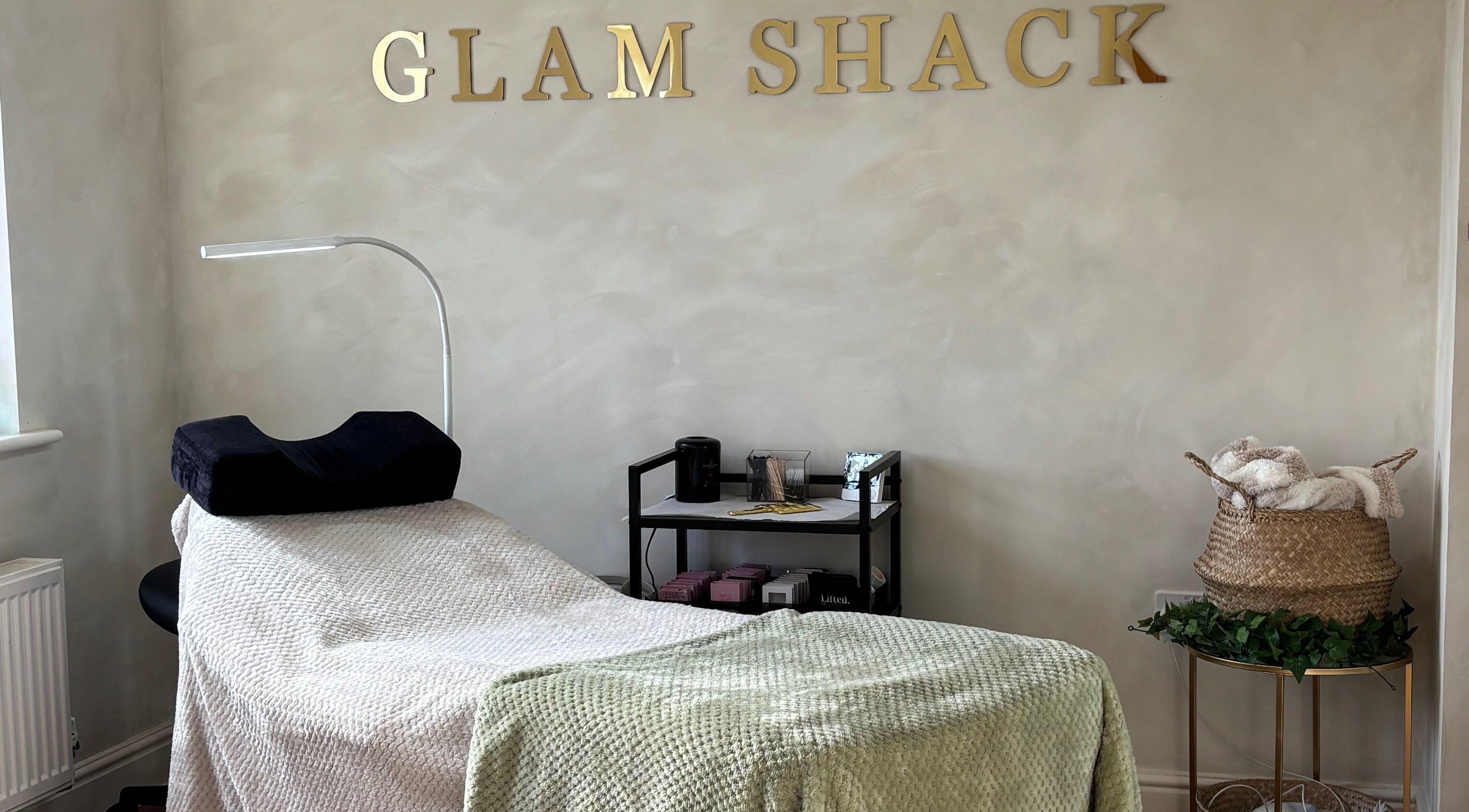 Relaxing treatment room at The Glam Shack in Mawsley, England, GB, with cozy decor and modern amenities.