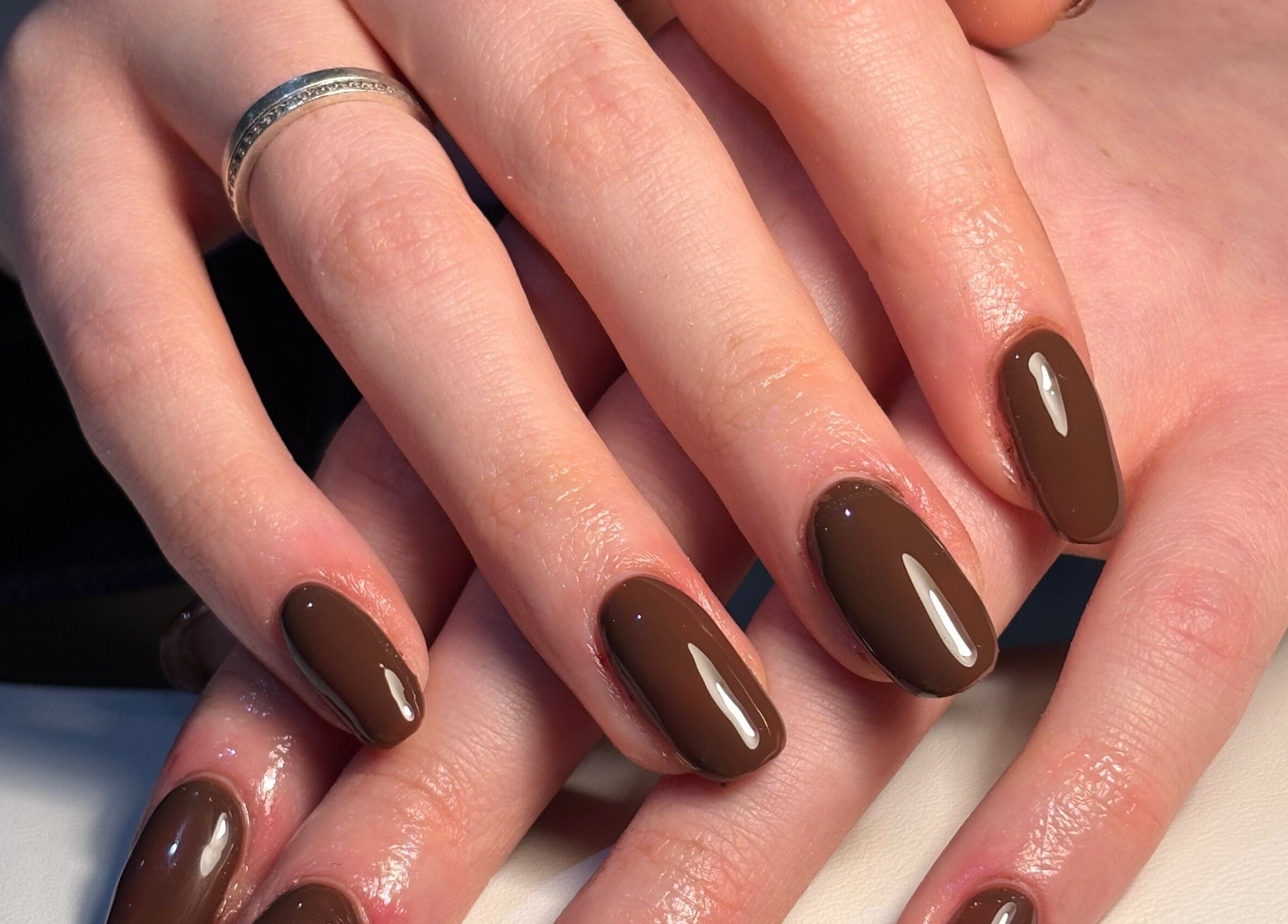 Elegant brown manicure at The Glam Shack, Mawsley, England, GB showcasing glossy nail finish.